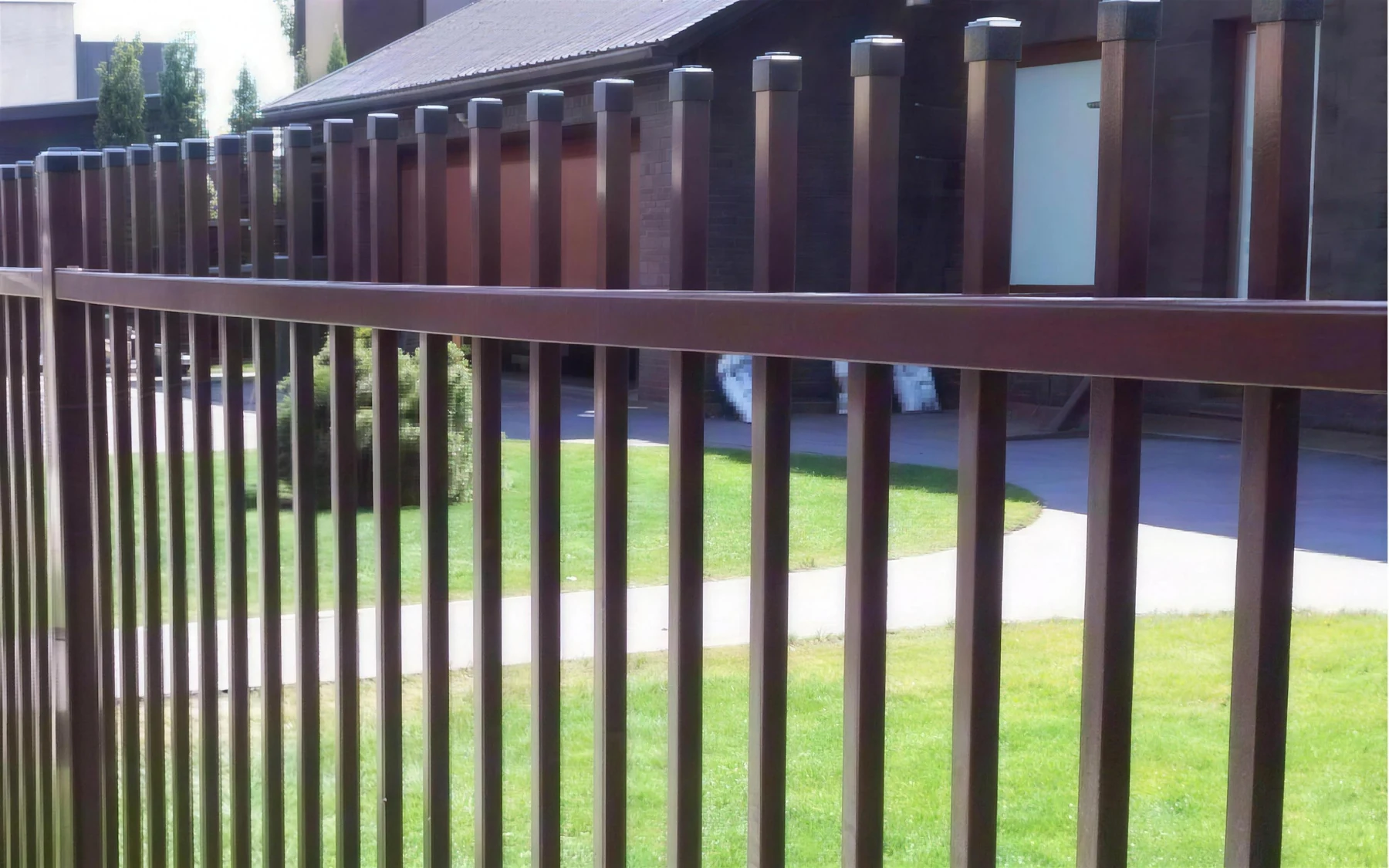 Classic welded bar metal fence in brown