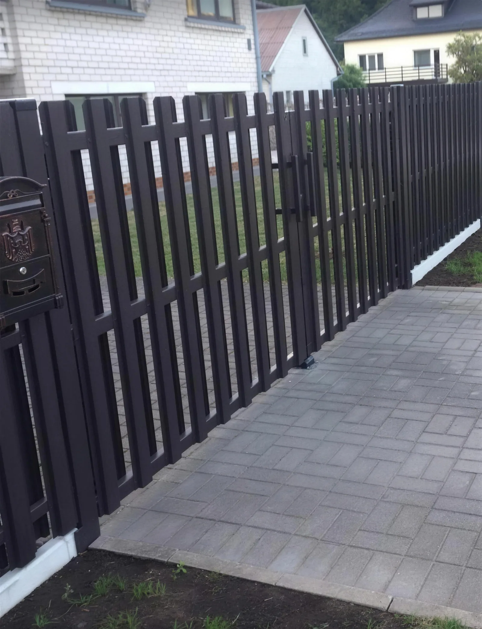 Dark vertical picket gates with letterbox